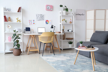 Interior of living room with workplace, sofa and shelf units