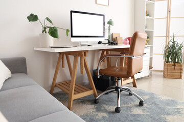 Interior of living room with workplace and shelf unit