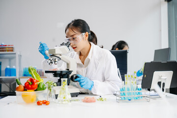 Food scientists in lab coats, testing samples, and analyzing food safety and quality in a laboratory