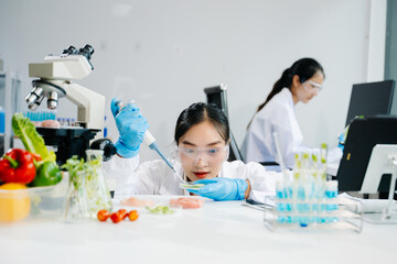 Food scientists in lab coats, testing samples, and analyzing food safety and quality in a laboratory