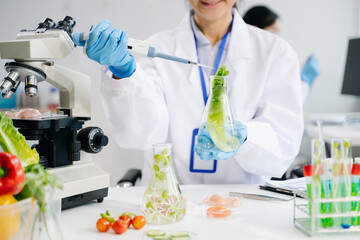 Food science as lab scientists test and analyze vegetables for safety and quality using advanced technology