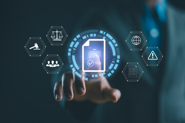 Compliance rules and law regulation policy concept. Businessman touch compliance icons on virtual screen for enforcement of laws, regulations, and standards.