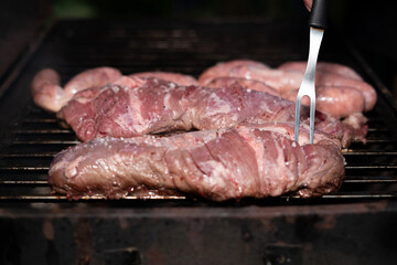 Asado meat being cooked over grill