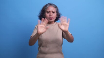 Frustrated annoyed irritated middle age woman covering ears gesturing no, ignoring unpleasant noise loud voices