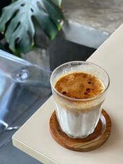Dirty Coffee - A glass of espresso shot mixed with cold fresh milk on blurred background and copy space, Perfect drink for summer time.
