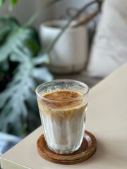 Dirty Coffee - A glass of espresso shot mixed with cold fresh milk on blurred background and copy space, Perfect drink for summer time.