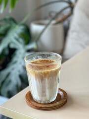 Dirty Coffee - A glass of espresso shot mixed with cold fresh milk on blurred background and copy space, Perfect drink for summer time.