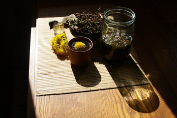 Dandelion honey jam, fresh and dried flowers in a beautiful aesthetic composition on the table.
