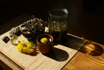 Dandelion honey jam, fresh and dried flowers in a beautiful aesthetic composition on the table.