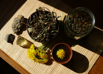 Dandelion honey jam, fresh and dried flowers in a beautiful aesthetic composition on the table.