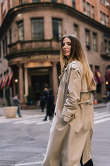 Chic Street Fashion Stylish Model Strutting in Trendy Trench Coat on the Streets