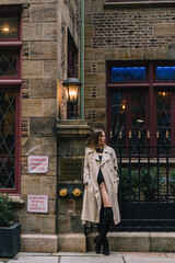 Chic Street Fashion Stylish Model Strutting in Trendy Trench Coat on the Streets