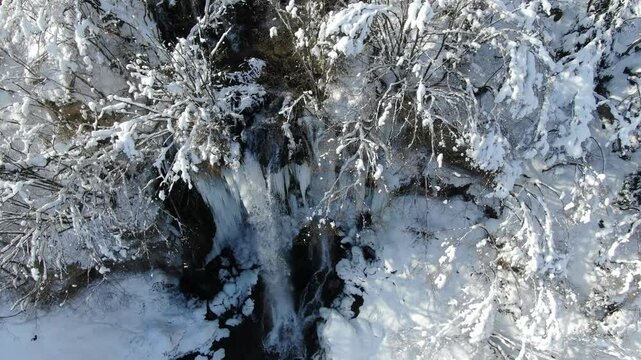 Aerial View of Gostilje Vodopad, Serbia. Natural Cold Water Pool and Waterfall on a Winter Day, Drone Shot