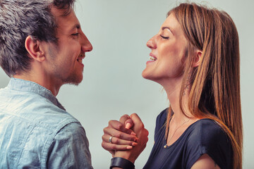 Playfully boastful, they hold hands with smiles