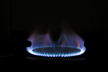 Blue Flame on Gas Stove in Dark Kitchen