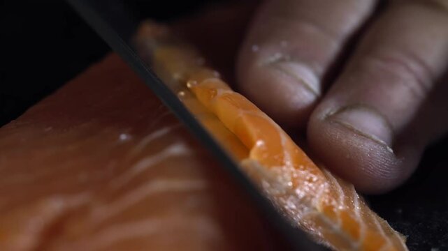 Salmon Fillet Being Carefully Sliced. Macro shot.