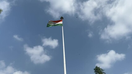 Indian national flag (Tiranga) fluttering against cloudy sky