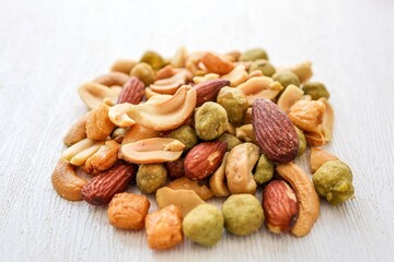 Mixed nuts with rice crackers roasted and salted on white background