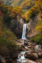 紅葉に染まる苗名滝と川の流れ