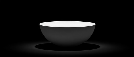 A minimalist black and white bowl on a dark background.