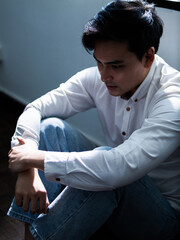 Contemplative young man indoor space portrait photography natural light environment introspective viewpoint emotional connection