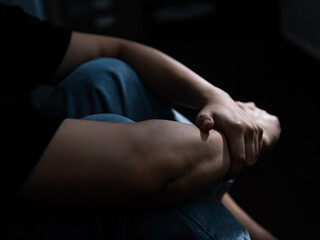 Contemplative moment individual reflecting in dim room personal reflection indoor setting close-up view emotional awareness