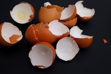 Many Chicken egg shells isolated on dark background, close up view.
