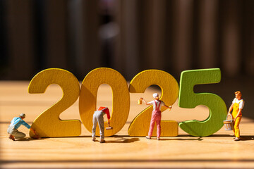 Miniature figurines painting large, colorful 2025 numbers, Perfect for New Year's promotions