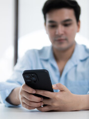 Checking notifications on smartphone indoor office technology lifestyle minimalist environment close-up view digital communication concept