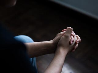 Contemplative gesture of hands indoor setting human emotions soft lighting close-up viewpoint reflection on mindfulness and peace