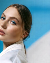 Ethereal Beauty Portrait in White Against Gradient Blue Sky Background