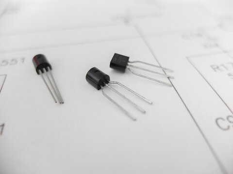 Various integrated circuits, microcontrollers in DIP SOIC TQFP packages. On the back there is a schematic diagram
