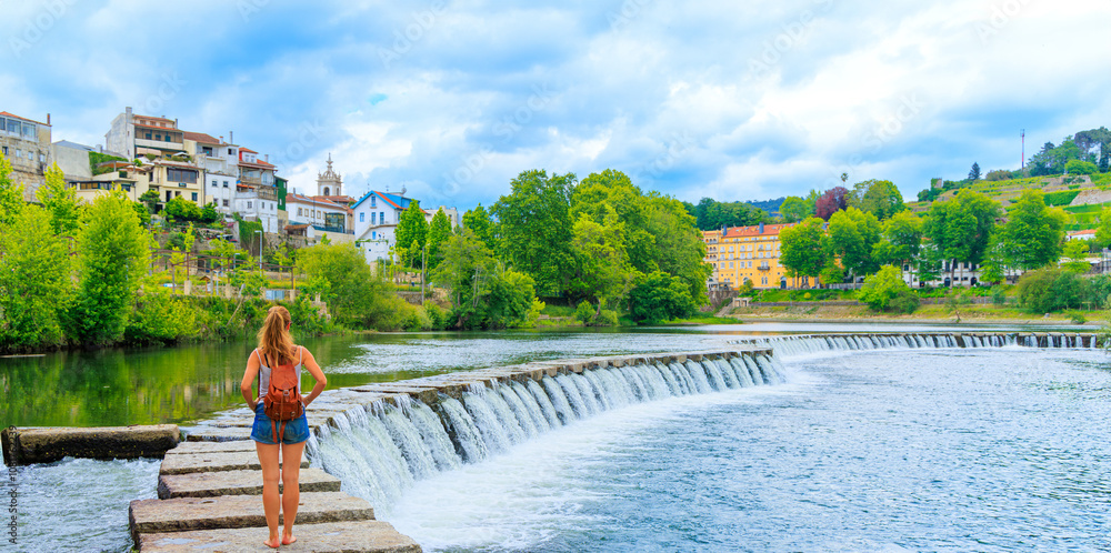 Wall mural woman tourist looking at panoramic view of Amarante city in Portugal