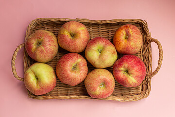 Fresh red apples in basket isolated on white background.