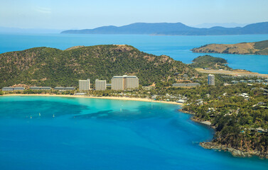 Stunning aerial view of Hamilton Island in the Whitsunday Islands, Queensland, Australia, showcasing turquoise waters, lush greenery, and white sandy beaches