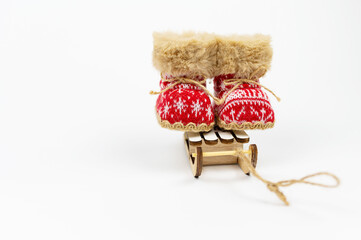 Concept Decoration. Red Nicholas Christmas on Sled boots isolated on white background. Winter boots, snow boots. New Year. NATIONAL SHOE THE WORLD DAY. Navidad