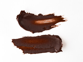 Chocolate brown paint strokes on white background