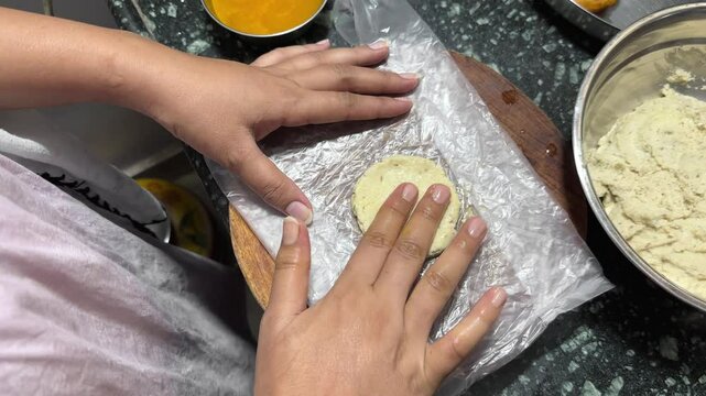 Vada making, Indian women making lentil fritters also called dal vada at home