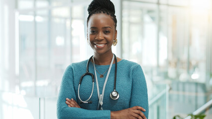 Black woman, doctor and smile with arms crossed at clinic on portrait with pride for healthcare in...