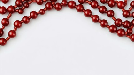 Obraz premium A collection of red beads arranged on a white background, suggesting decorative use.