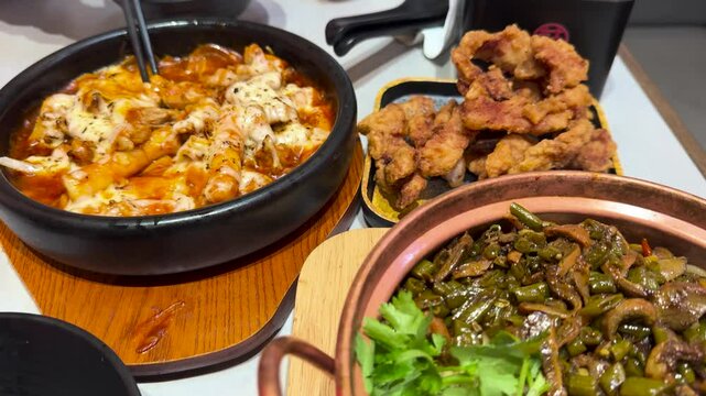 Korean cheese toppoki and Chinese oil dry noodles served with deep-fried chicken served in a restaurant in New Zealand
