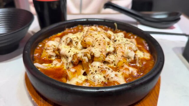 Korean cheese toppoki and Chinese oil dry noodles served with deep-fried chicken served in a restaurant in New Zealand