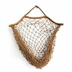A brown fishing net hanging against a white wall.