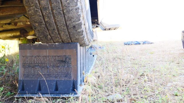 Camper leveling block in use. Leveler ramp chock blocks for caravan rv travel trailer. Accessories for motorhome.
