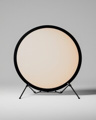 A round, light-colored backdrop on a stand, ideal for photography and studio use, providing a clean and smooth surface for portraits or product shots.