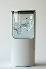 A white cylinder with water and a large ice cube