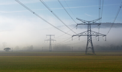 Characteristic masts and lines of the electrical distribution network can be found scattered throughout Slovakia. High voltage power lines in the fog.