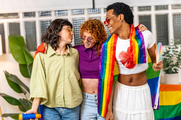 Multi-ethnic lgbt friends partying with rainbow flags at home