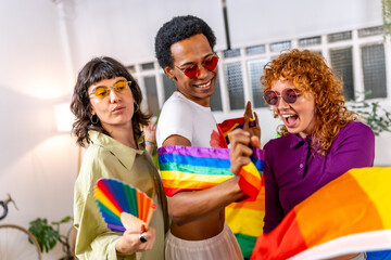 Happy non-binary people dancing with rainbow flag
