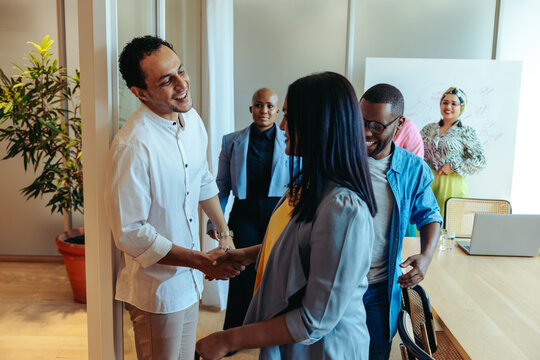Business team saying goodbye to a client after a successful meeting